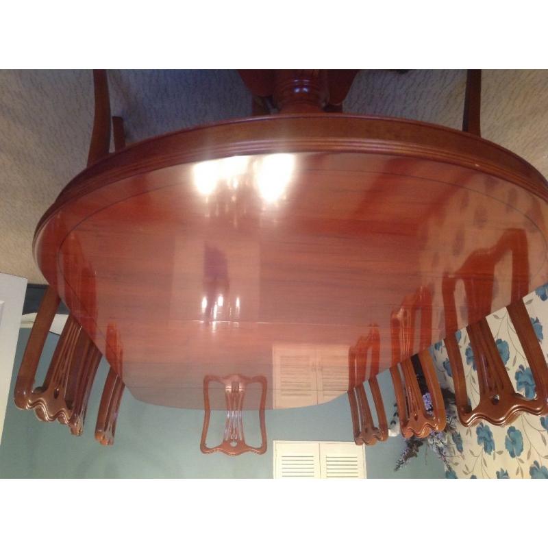 Yew wood extending dining table with eight chairs and table protector mats