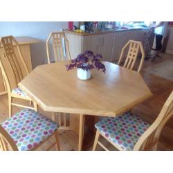 Extending dining table, 8 chairs and sideboard light coloured wood