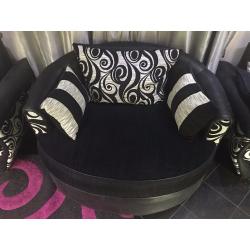 Black and white circular sofa, which rotates left and right 360 Degrees.