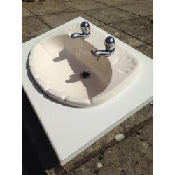 Cream bathroom ceramic basin and taps