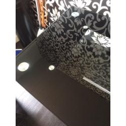 Black gloss dining table with glass top and chrome legs