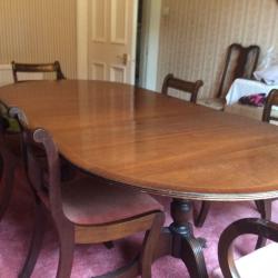 Antique dining table which extends and 6 dining chairs, 2 with arms