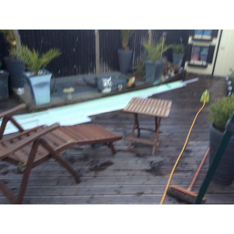 Teak garden loungers and small table
