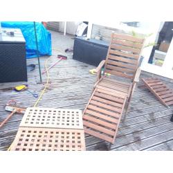 Teak garden loungers and small table