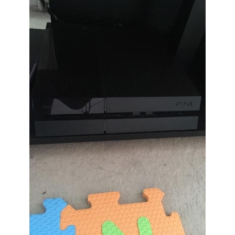 PS4 with controller and game